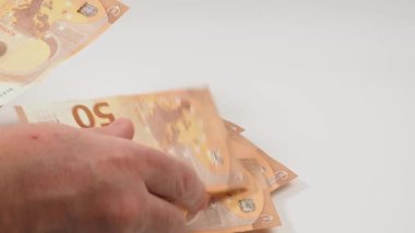 Counts money euro banknotes on a white background. close-up.