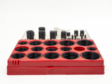 Hydraulic and pneumatic o-rings in black in different sizes on a white background. Rubber gaskets for plumbing. copy space.