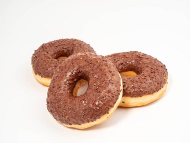Chocolate donut with chocolate chips on a white background. close-up.