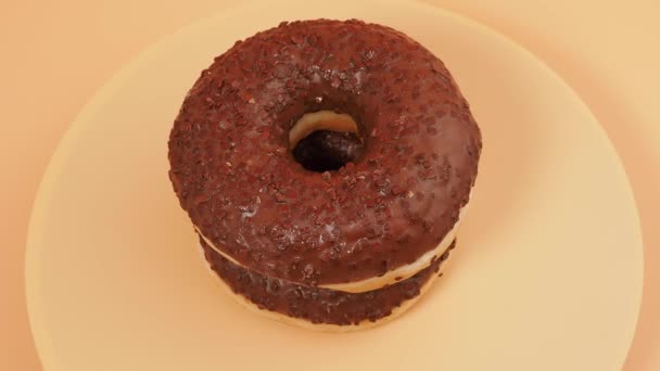 Rotating Chocolate Donut Chocolate Chips Orange Background Close — Vídeo de Stock