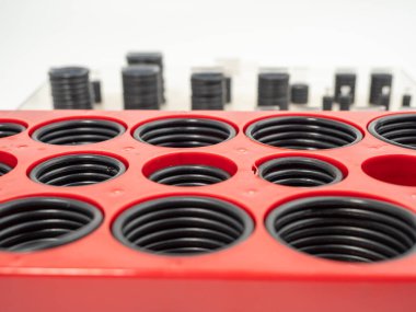 Hydraulic and pneumatic o-rings in black in different sizes on a white background. Rubber gaskets for plumbing. copy space.