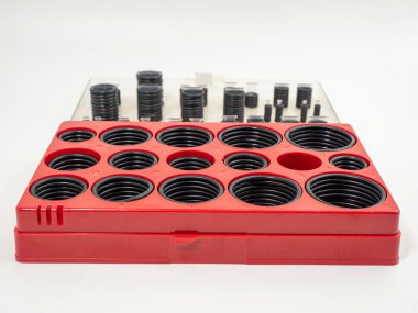 Hydraulic and pneumatic o-rings in black in different sizes on a white background. Rubber gaskets for plumbing. copy space.