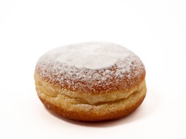 Freshly baked and dusted with powdered sugar German donuts. Donut berliner or krapfen on white background.