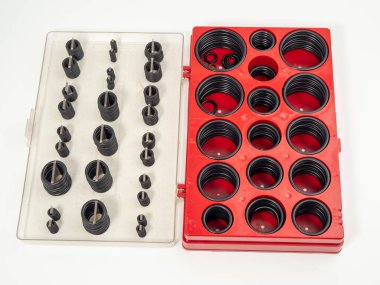 Hydraulic and pneumatic o-rings in black in different sizes on a white background. Rubber gaskets for plumbing. copy space.