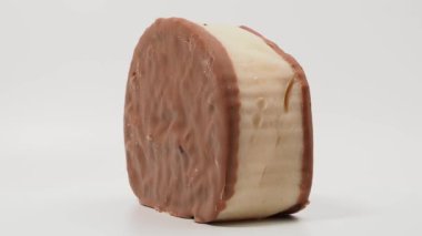 A piece of chocolate cake rotating on a white background. A piece of chocolate cake.