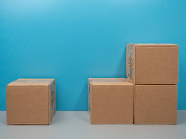 Humanitarian aid. Cardboard boxes with donations on a blue background. Close-up.