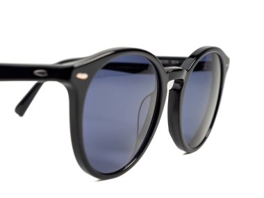 Stylish sunglasses. Sunglasses in a dark frame on a white background. Close-up.