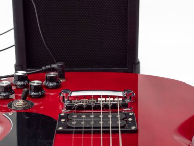 Kırmızı elektro gitar ve klasik amplifikatör. Müzik aleti gitarı. Yakın plan..