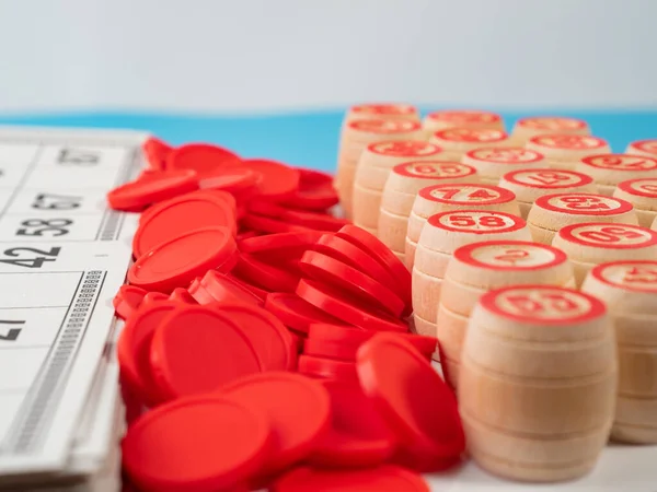 stock image Board game bingo. Wooden barrels with lotto numbers, playing cards for the game. Close-up.