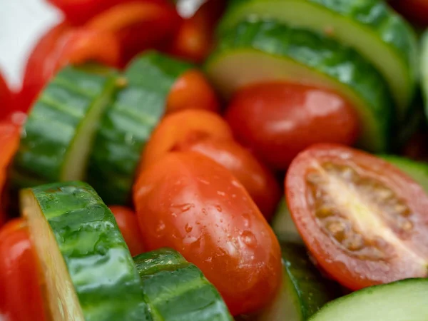 stock image Chopped cucumbers and tomatoes. Salad with cucumbers and tomatoes. close-up.