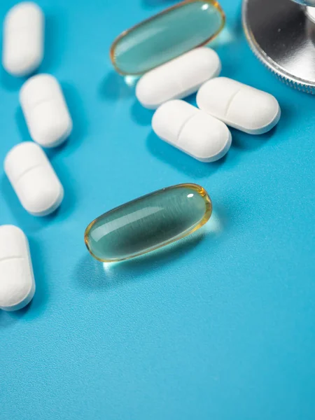 Pills and medicine on a blue background. Medicine concept. Close-up.