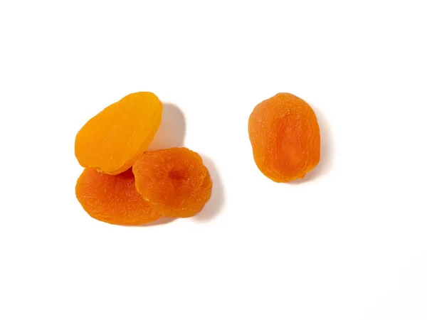 stock image Wooden bowl of dried apricots on a white background, selective focus. Dried apricots close up.