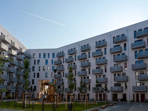 Yard area of a modern European residential complex, multi-storey residential buildings with a playground and benches. New building of the European city.
