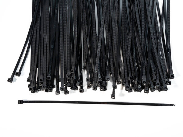 Plastic black ties on a white background. Plastic ties for cables.