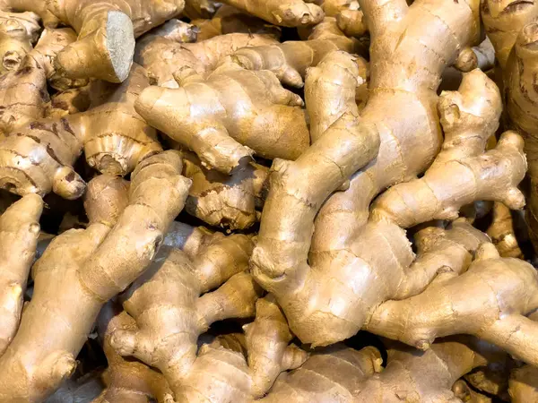Fresh raw ginger all over background, close up. ginger root.