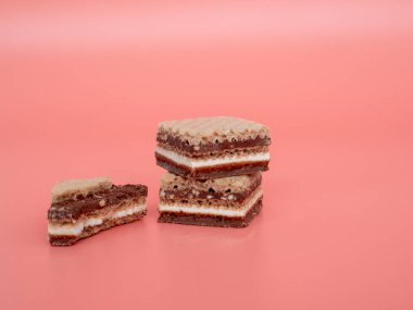 Pembe arka planda fındıklı lezzetli çikolatalı gofretler. Çikolatalı ve fındıklı gofretler..