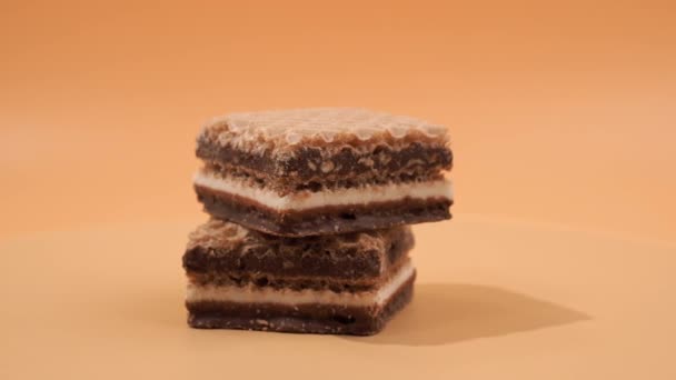 Fındıklı Çikolatalı Gofretler Turuncu Arka Planda Dönüyorlar Çikolatalı Fındıklı Gofretler — Stok video