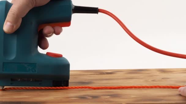 Close Man Hand Holding Electric Stapler Fastening Rope Board Electric — Stock Video