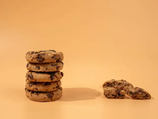 Oatmeal cookies with chocolate chips on an orange background. Classic oatmeal cookies with chocolate.