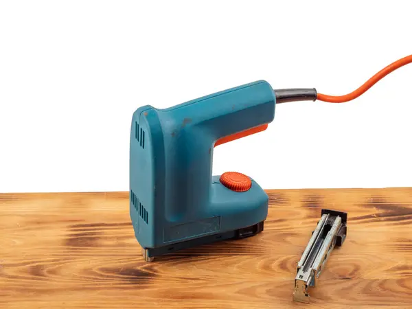 Electric stapler on a white background. Electric staple gun close-up.