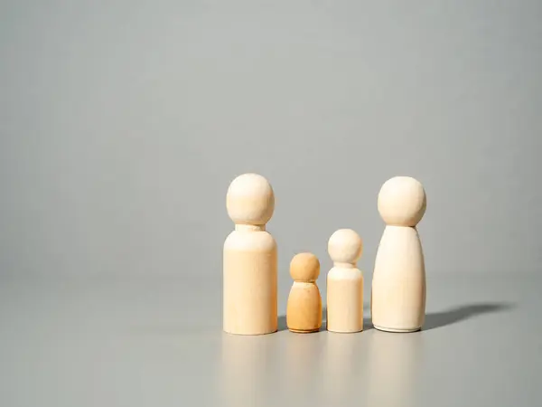 Wooden figures. Family on a gray background. Family values concept.