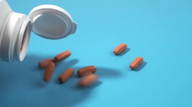 Plastik bir şişeden mavi bir yüzeye ilaç döker. Tıbbi haplar. Yakın çekim..