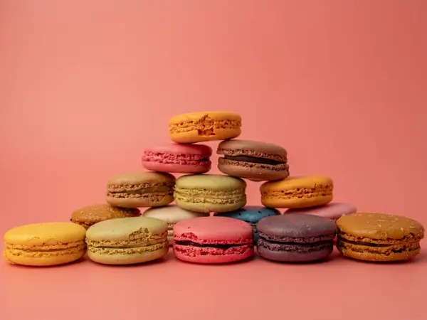Colorful French macaroons on a pink background. French macaroons close-up.