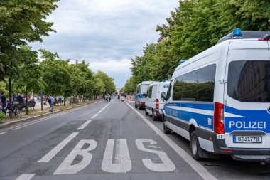 Almanya 14 Haziran 2024 Bir dizi polis minibüsü caddeye park etti. Sokaklar boş ve gökyüzü bulutlu.