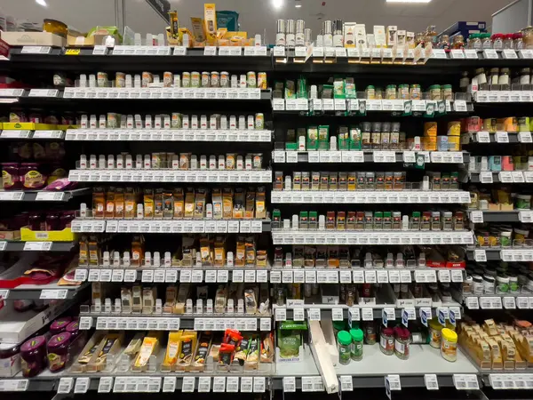 stock image Germany Berlin August 12, 2024. A store shelf with many spices and herbs. The spices are organized in rows and are labeled with numbers