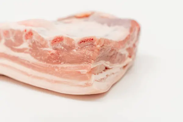 stock image A piece of meat with a white background. The meat is cut in half and has a pinkish color Pork meat isolated on a white background.