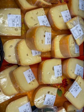 Almanya 4 Eylül 2024. Üzerinde beyaz etiketler olan bir sürü peynir. Peynir sarı ve plastik bir torbada.