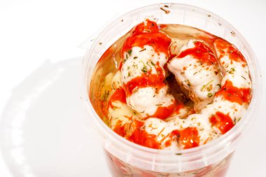 Container with Surimi in the form of shrimp on a white background. clipart