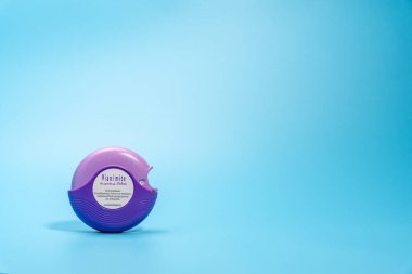 Germany Berlin November 21, 2024. Purple asthma inhaler on blue background. clipart