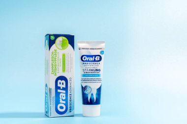 26 Kasım 2024 'te Almanya' da mavi arka planda bir tüp diş macunu ve bir kutu diş macunu sergilenmektedir. Diş macununun adı Oral B ve popüler bir markadır.
