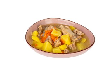 Et ve sebzeli bir kase yemek. Kâse pembe ve beyaz bir arka planı var. Yiyecek, havuç ve patates de dahil olmak üzere et ve sebzelerin bir karışımı.