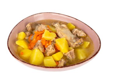 Bir kase et ve havuçlu çorba. Kase pembe ve çorba sarı. Çorbada çok havuç var.