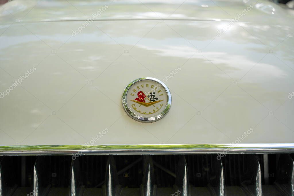 Germany Berlin May 11, 2025. Chevrolet Corvette Emblem on Hood. A classic Chevrolet Corvette emblem adorns the cream-colored hood with a noble shine. The symbol represents American sports car tradition and timeless elegance.