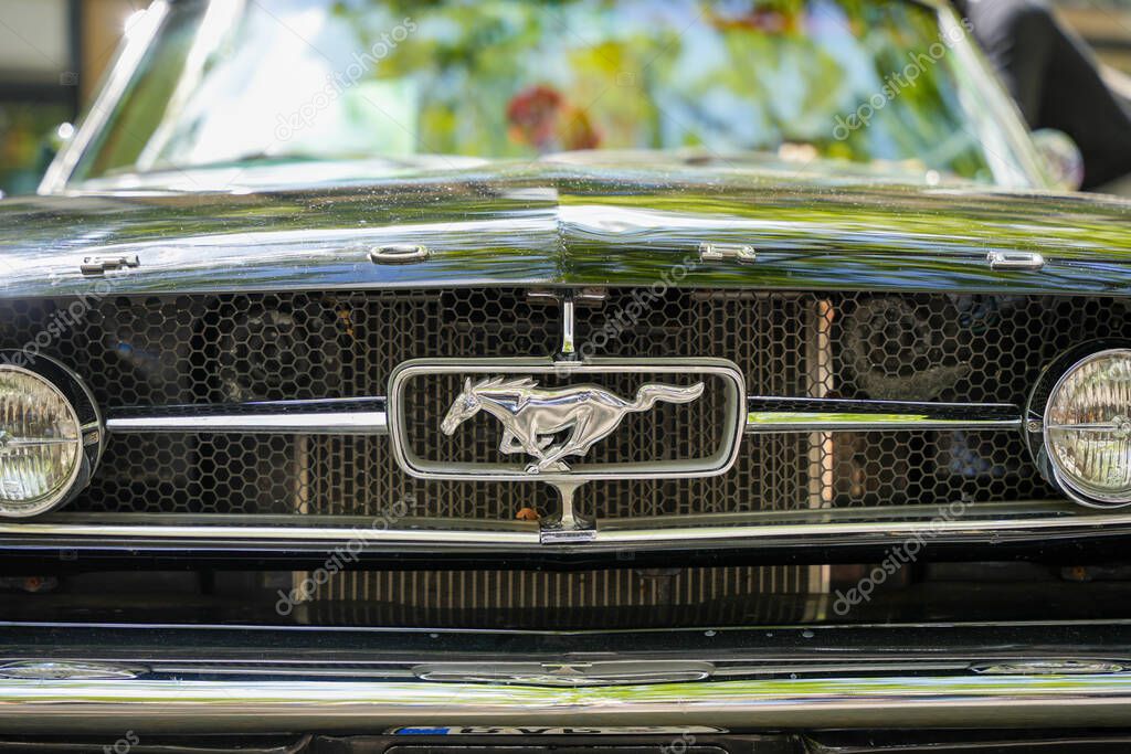Germany Berlin May 11, 2025. Ford Mustang Front Grille. The iconic galloping Mustang in the Ford Mustang's grille. The honeycomb grille with chrome details represents power and American automotive tradition.
