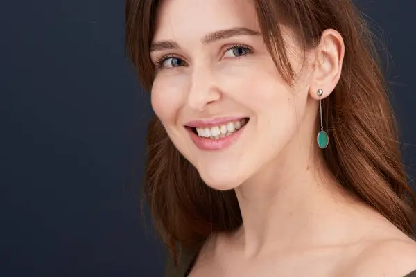 真っ白な歯と緑の目を持つ美しい若い女性のクローズアップポートレート ストック写真