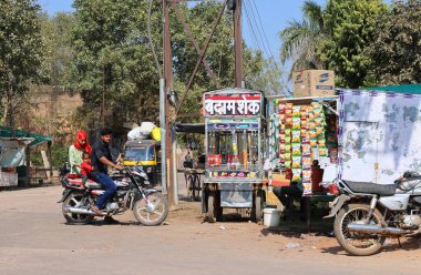 RURAL RAJASTHAN INDIA - 02 15 2023: sokak tezgahında abur cubur satan adam