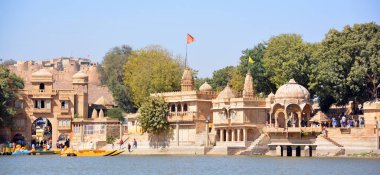 JAISALMER RAJASTHAN INDIA - 02 13 2023: sabah Gadisar Gölü. Jaisalmer 'de tapınakları olan insan yapımı su deposu. Rajasthan. Hindistan 