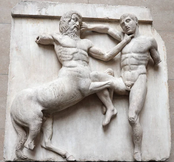 stock image LONDON UNITED KINGDOM 06 17 2023: South Metopes in the British Museum show the battle between Centaurs and Lapiths at the marriage feast of Peirithoos.