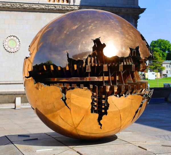 DUBLIN REPUBLIC OF IRELAND 05 28 2023: On the podium of the iconic brutalist Berkeley Library is Sfera con sfera ('Sphere within sphere'). Properly part of Trinity College Dublin's Art collection