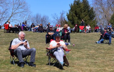 BROMONT QUEBEC CANADA 04 08 2024: People waiting for the Solar eclipse of April 8, 2024. visible across a band covering parts of North America, from Mexico to Canada and United States of america clipart