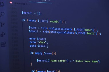 The software developer is doing php coding. Abstract code background. Selective focus code on computer screen