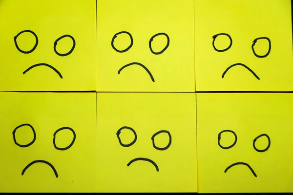 Happy and unhappy concept. Background of green sticky notes. Happy sticky note is among unhappy sticky notes