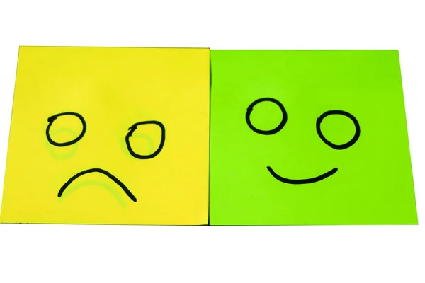 Happy and unhappy concept. Background of green sticky notes. Happy sticky note is among unhappy sticky notes