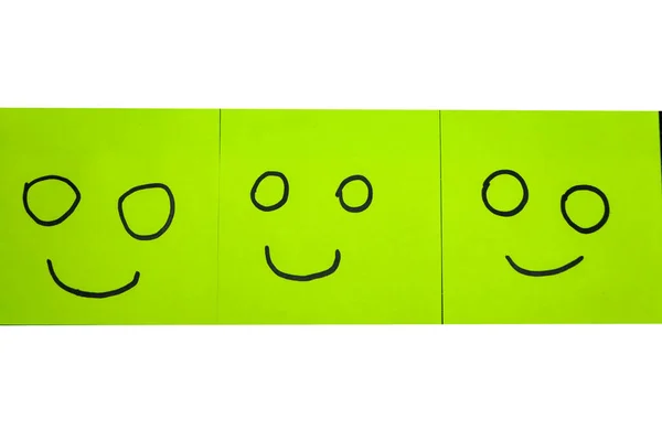 Unhappy and happy concept. Background of sticky notes. Green sticky note is among yellow sticky notes.
