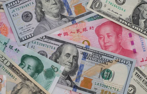 Close up yuan banknotes and dollar banknotes. The concept of the trade war between China and the United States
