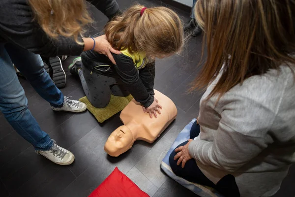 stock image three people practice first aid and cpr resuscitation with a cpr resuscitation manikin